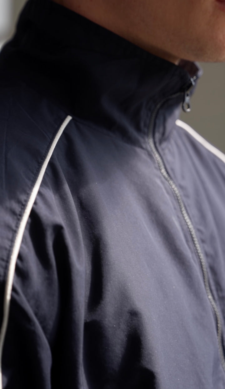 Close-up of the navy Aesthetics Club Jacket&