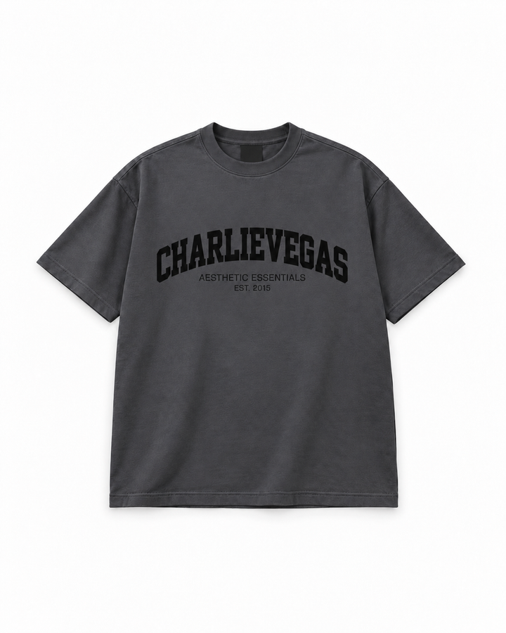 Varsity Tee V2 in charcoal with black CHARLIEVEGAS print, flat lay